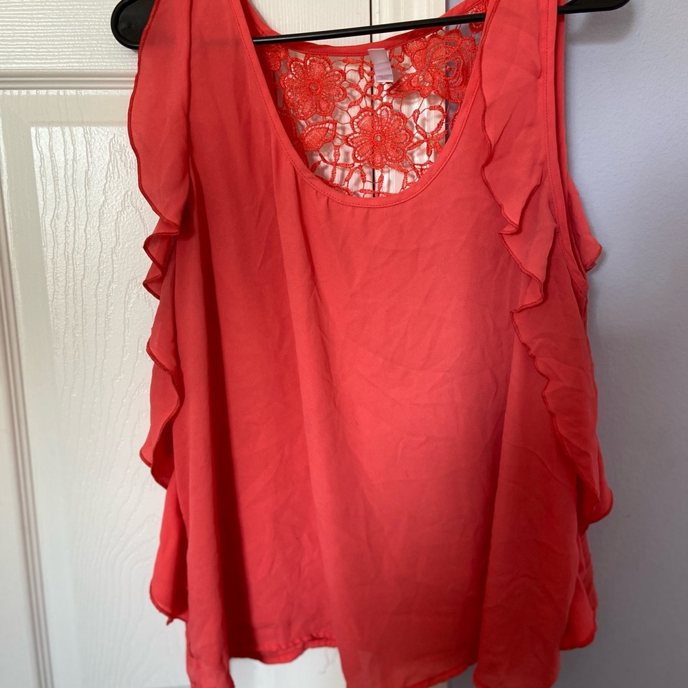 Orange sleeveless top with side ruffles